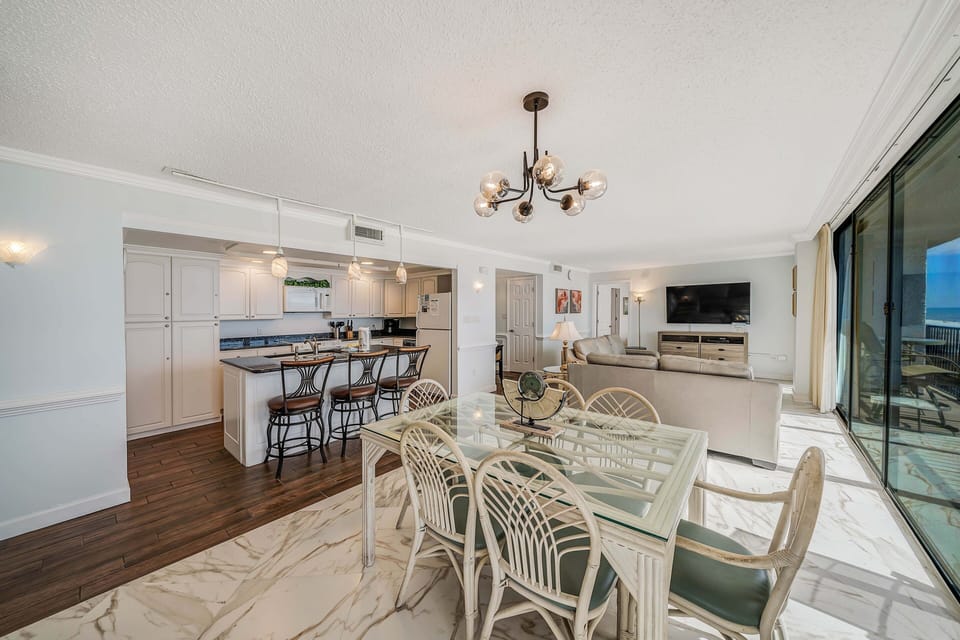There is a dining table that seats 6, perfect to enjoy a meal or play a game, as well as additional breakfast bar seating.