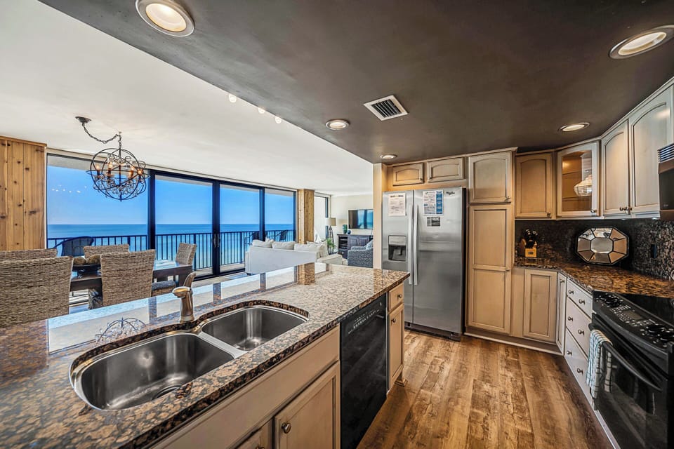 The fully equipped kitchen features granite countertops, stainless-steel appliances, and everything you need to prepare meals for family & friends.
