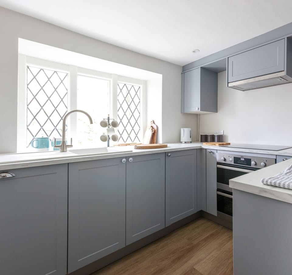 Kitchen offering beach glimpses through the trees.