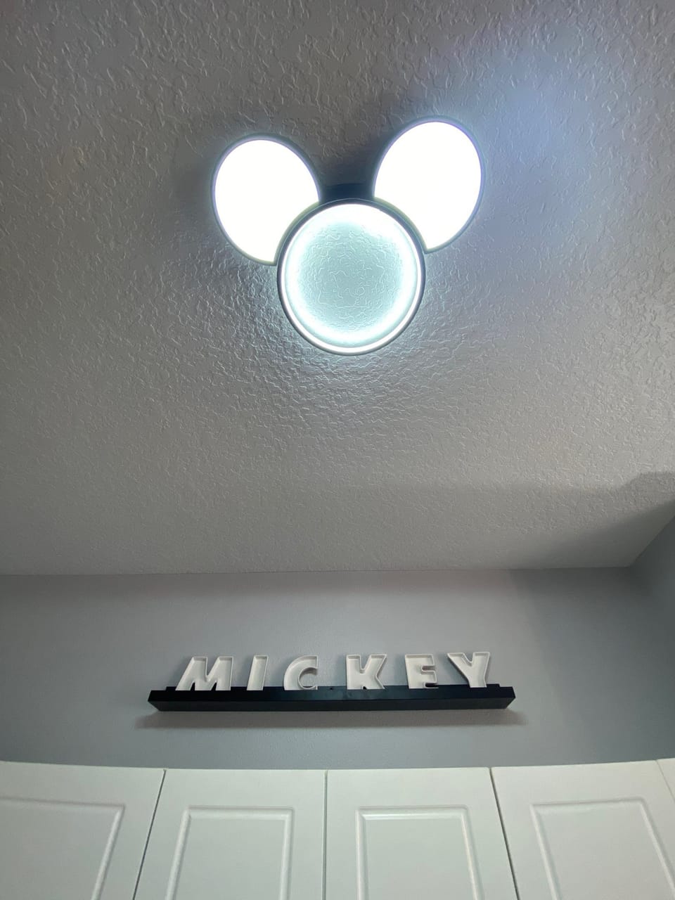 Fun Mickey-shaped light fixture adding a unique Disney charm to the decor.
