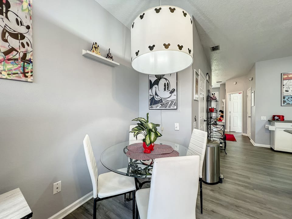 Cozy dining nook with a chic Mickey-inspired chandelier and inviting seating.