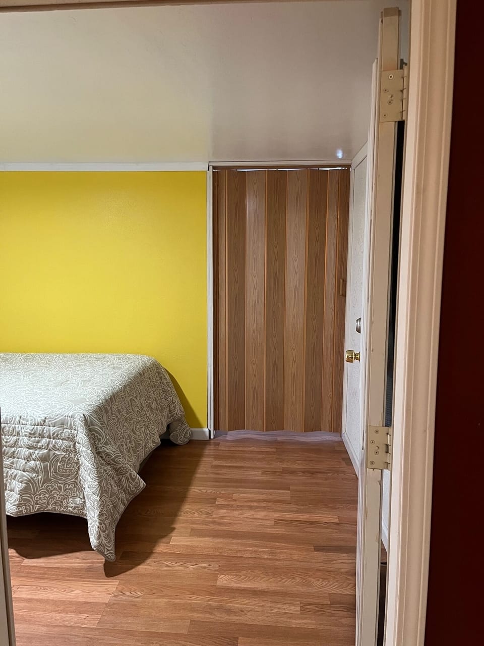 Looking from living area to small bedroom, accordian door closed