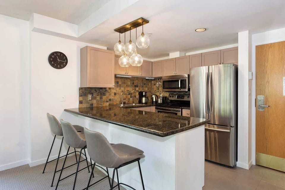 - Modern kitchen with stainless steel appliances and granite counters  
- Stylish backsplash and pendant lights for a warm inviting atmosphere  
- Perfect for cooking meals or enjoying morning coffee before the slopes  
