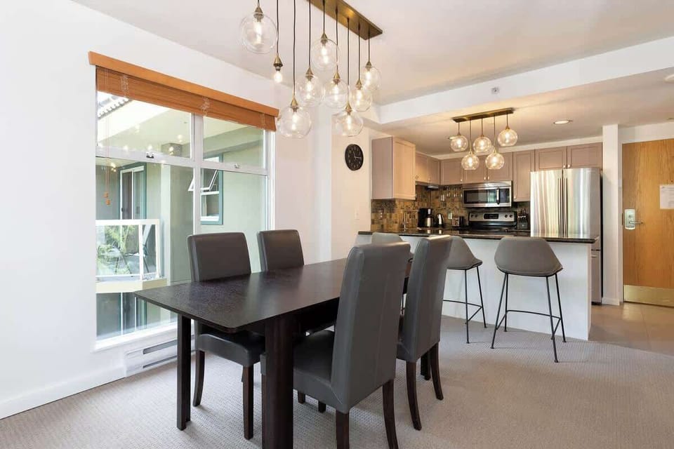 - Elegant dining area with modern lighting and natural window views  
- Open layout connecting kitchen and dining for seamless entertaining  
- Perfect for shared meals and relaxing evenings after mountain days  