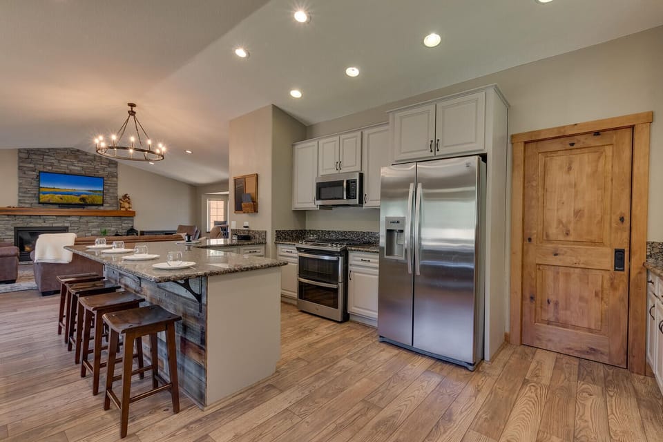 - Modern kitchen with stainless steel appliances  
- Granite island with seating for casual dining  
- Open-concept layout flows into living and dining