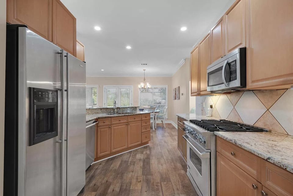 Kitchen complete with Viking gas stove, microwave, refrigerator with ice maker