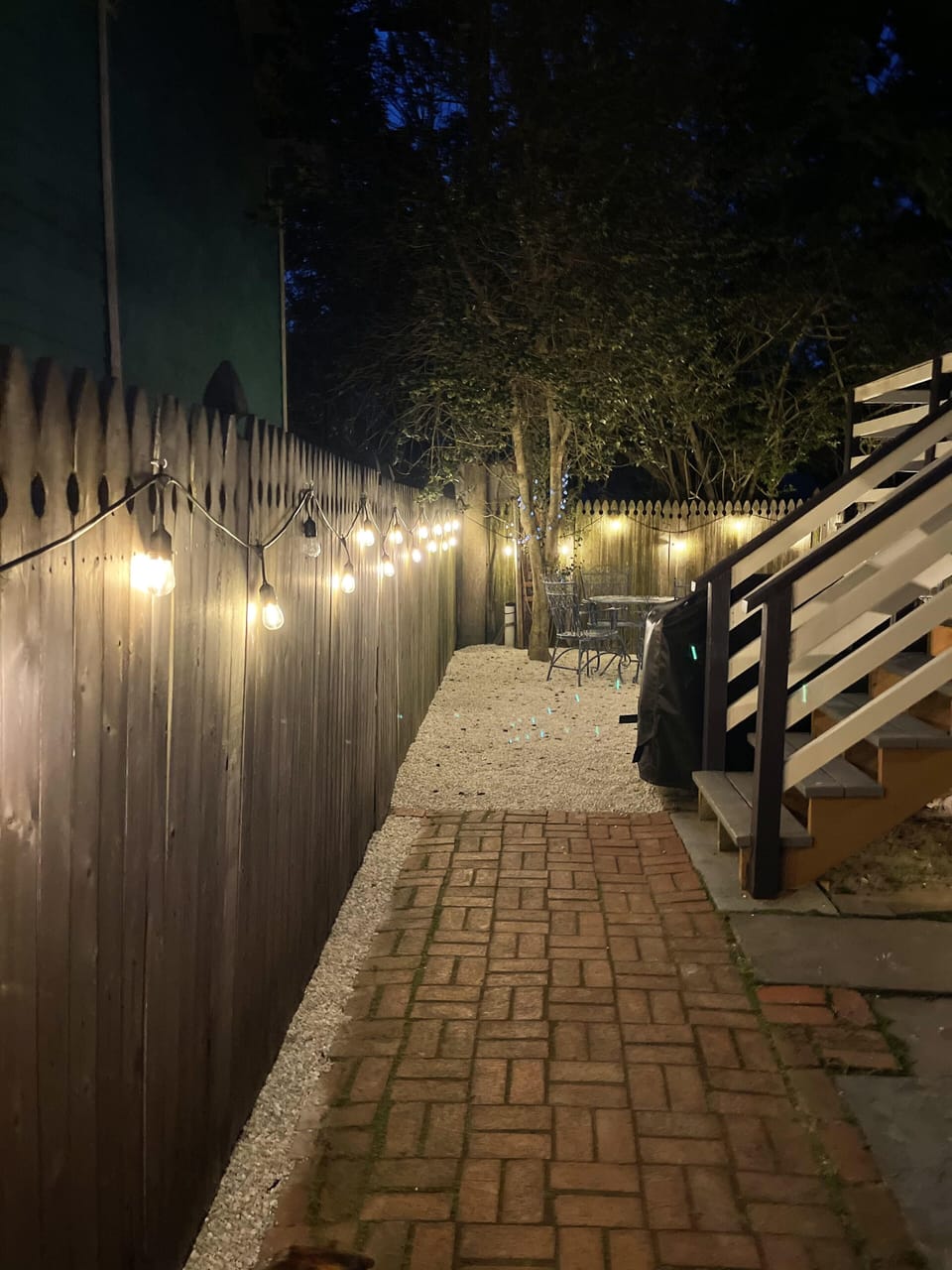 Rear yard with BBQ, tables and chairs.