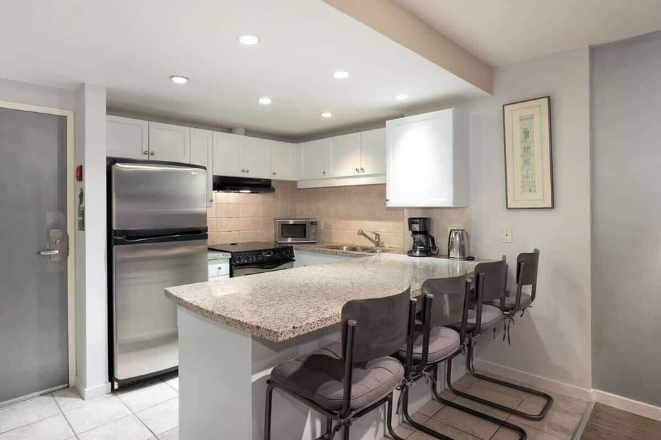 - Fully equipped Whistler kitchen with granite counters  
- Stainless steel appliances and bar seating for dining  
- Ideal for family stays and extended Whistler vacations  