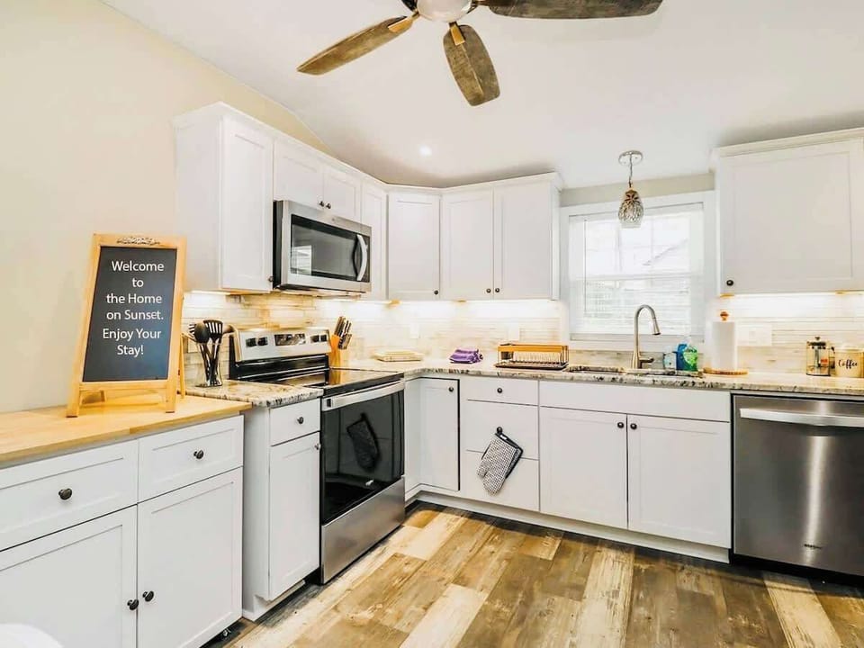 Fully stocked kitchen with new appliances and cooking supplies. 
