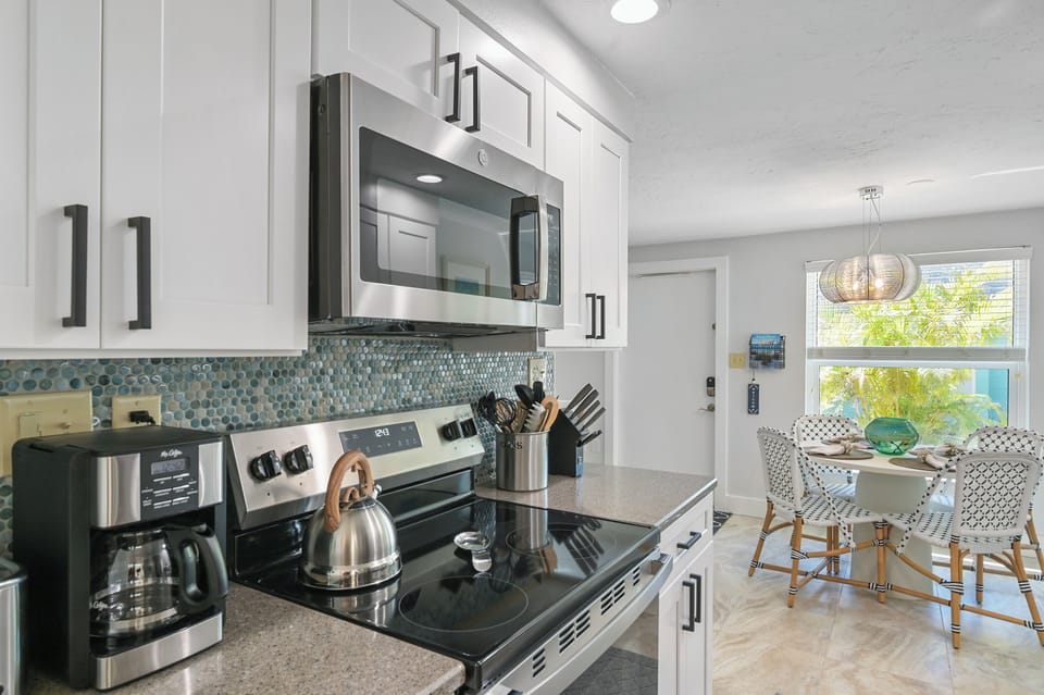 Fully equipped kitchen with smooth top electric range and microwave