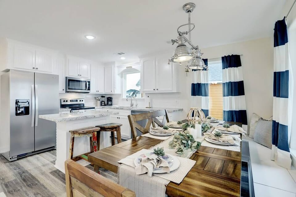 Breakfast nook with nine foot table. Custom nautical chandelier from actual ship