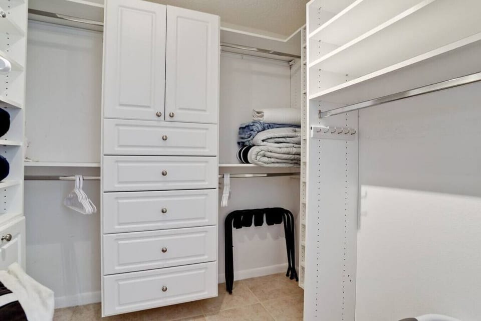 Walk-in closet w built in storage.