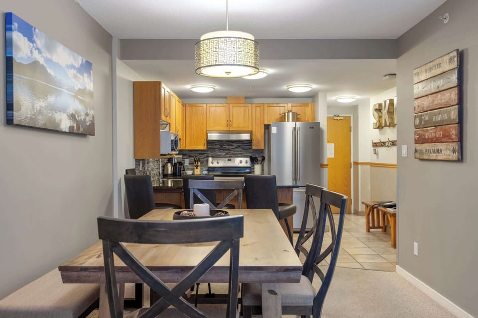 - Spacious dining space beside the open kitchen
- Seats up to eight for shared mountain meals  
- Overlooks the open-plan living area and fireplace 
