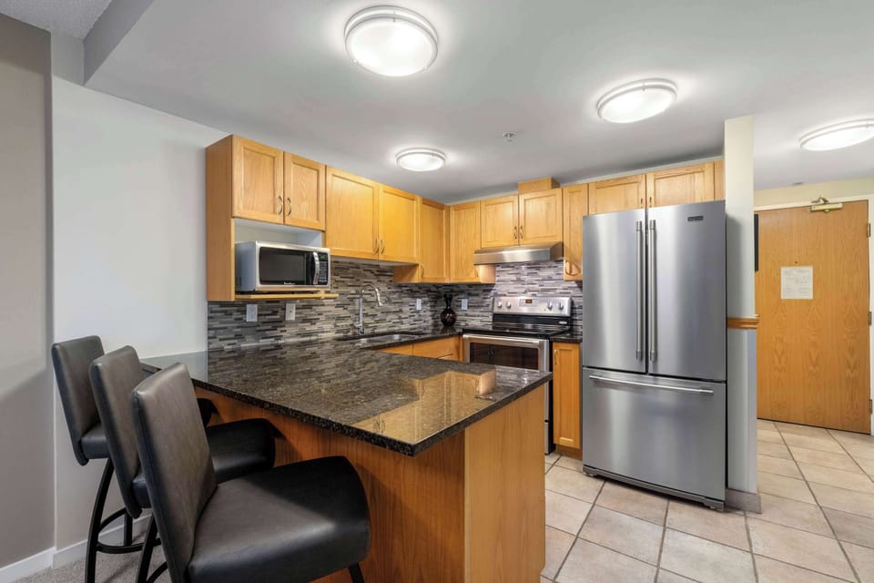 - Modern kitchen with stainless steel appliances and granite counters - Breakfast bar with seating for three adds extra space - Fully equipped for cooking and entertaining after a ski day
