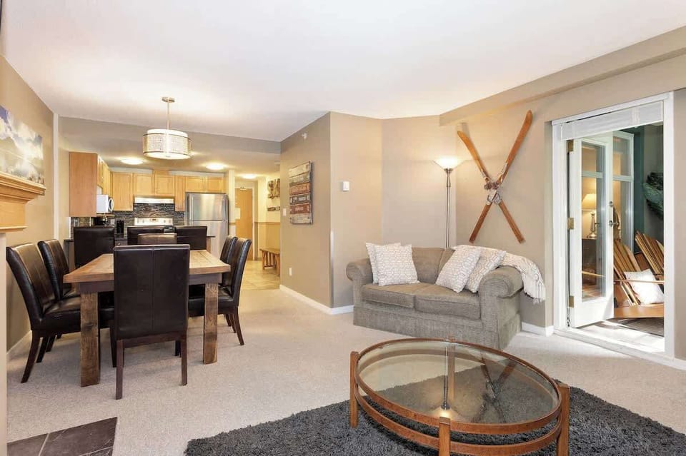 - Inviting living and dining area with ski-themed décor  
- Soft seating and warm lighting for cozy evenings  
- Direct balcony access to enjoy forest-fresh air  
