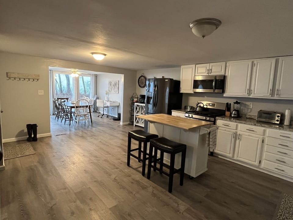 Kitchen, front entrance, and dining nook. View from living room.