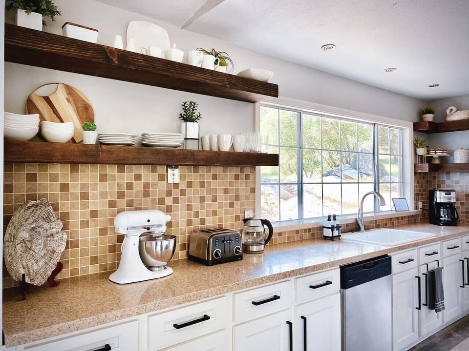 Floating shelves, real cookware, the KitchenAid that actually works. Set up for cooking, not just reheating.