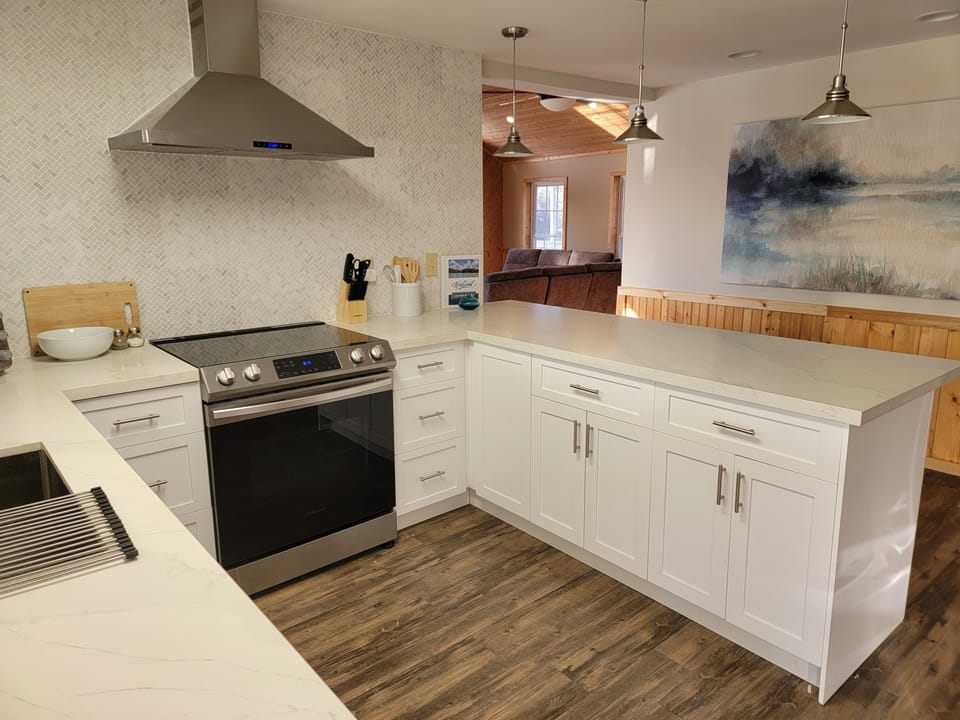 Prepare meals in this new, stocked kitchen with stainless steel appliances.