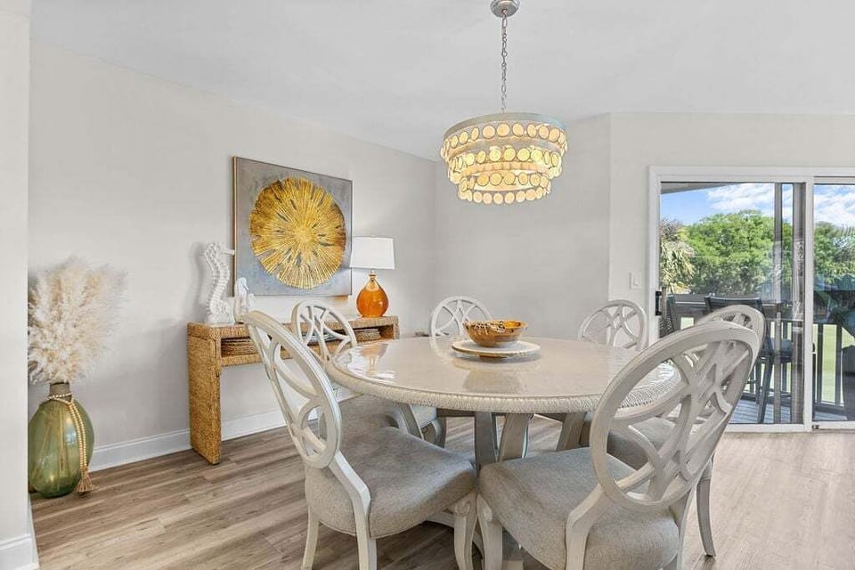 The dining area sits between the great room and the kitchen. A large table with seating for 6