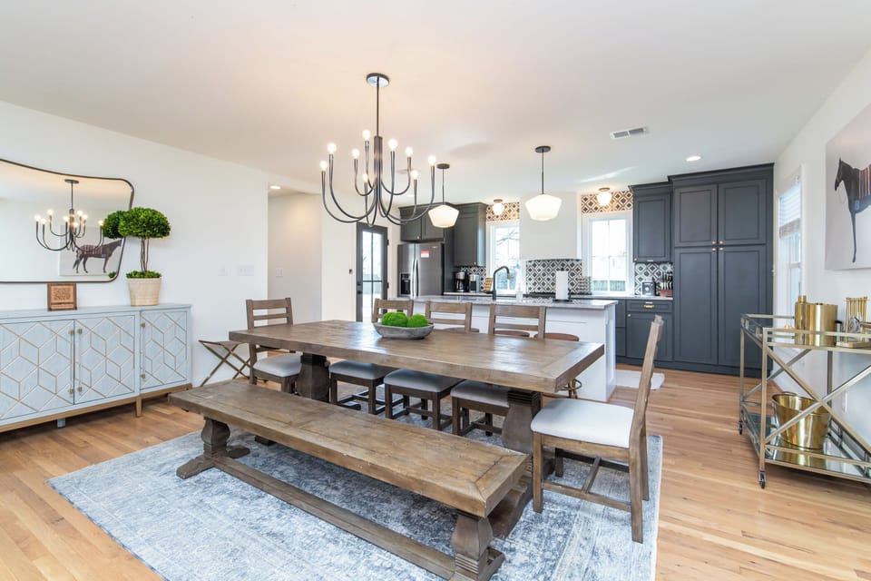 This stylish dining area features a classic farmhouse table for eight, creating the perfect backdrop for family dinners or casual get-togethers.