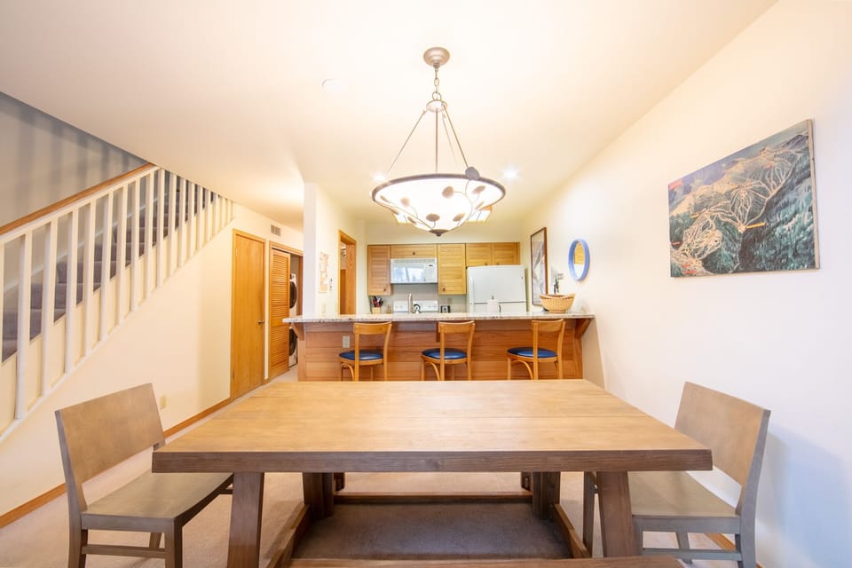 Your open-concept dining and kitchen space invites memorable meals, with warm wood tones creating the perfect atmosphere for gathering.