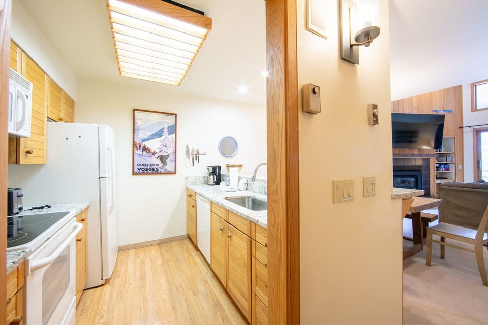 Your fully equipped kitchen features warm wood cabinets, granite counters, and skylights that bathe the space in natural light.