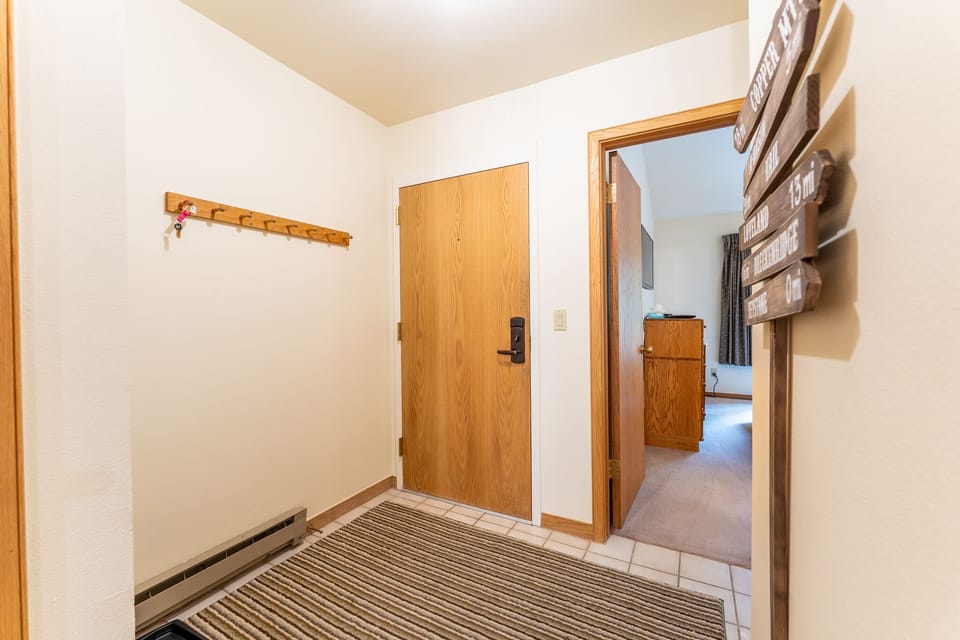 Step into your welcoming entryway with convenient coat hooks and thoughtful touches that make you feel right at home.