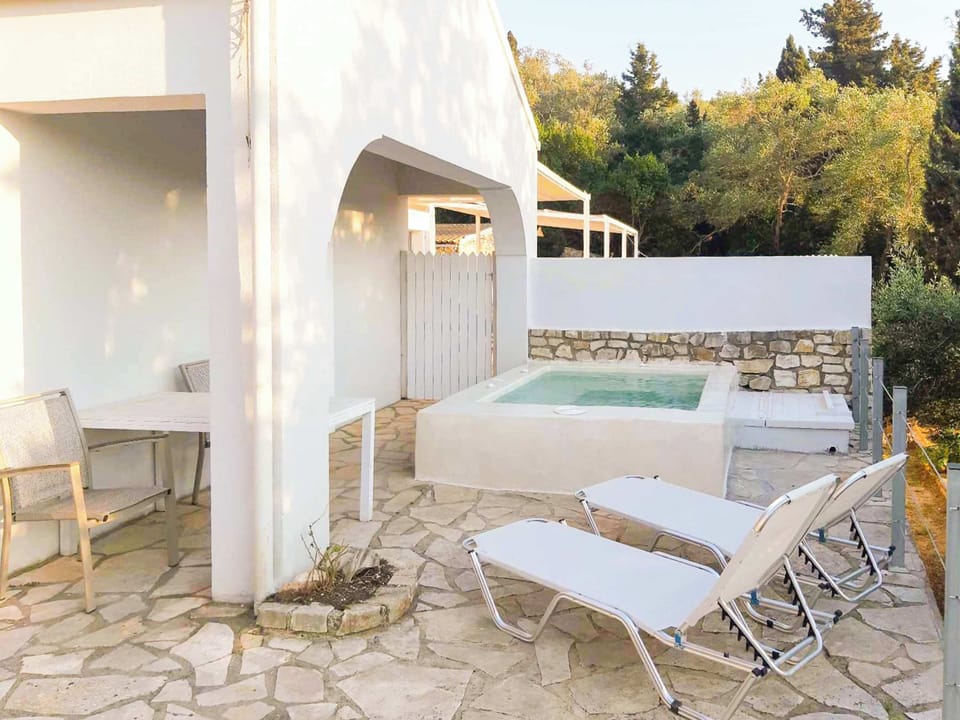 Shaded Outdoor Patio with Seating Area
Relax on the shaded patio, designed for quiet mornings with coffee or evenings spent enjoying the surrounding gardens.