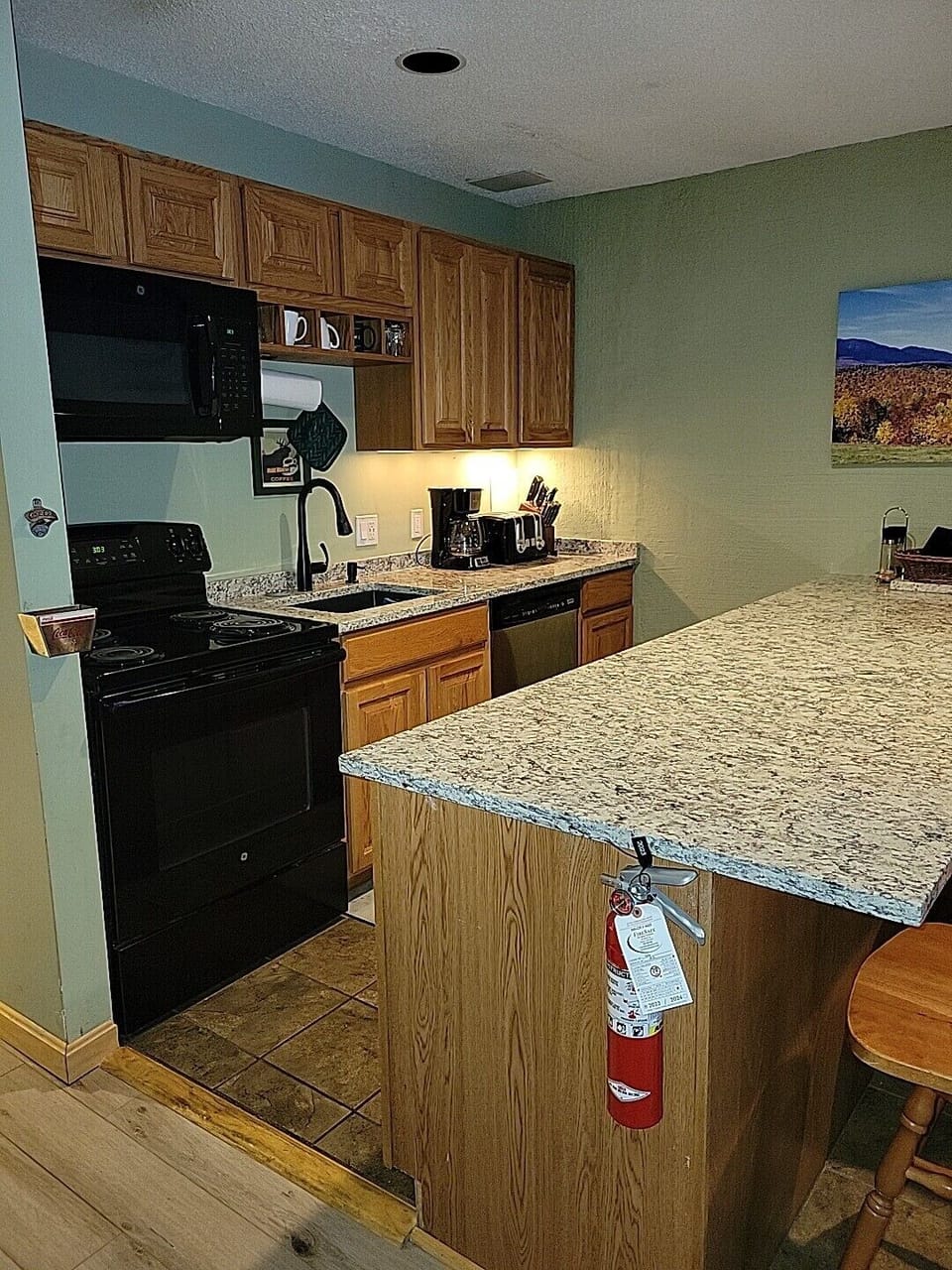 Kitchen with granite countertops, microwave, dishwasher, stove & fridge