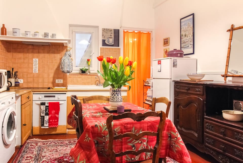 Kitchen has washer, oven, stovetop, microwave, coffee grinder and pot, kettle