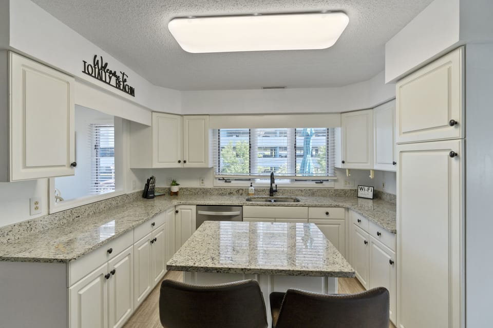 The kitchen island provides additional counter space for serving snacks or meals