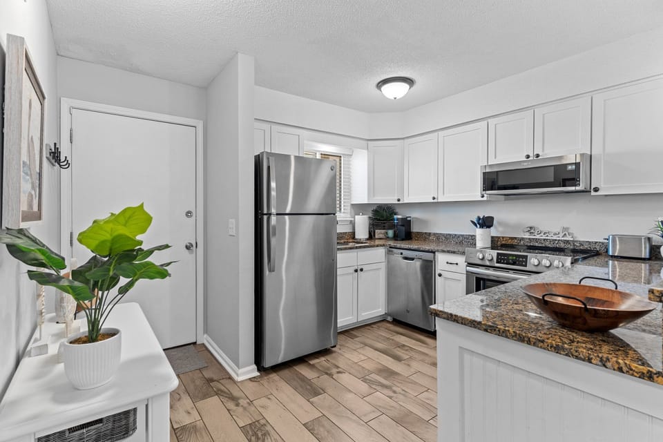 Your bright, modern kitchen features stainless steel appliances and granite countertops, perfect for preparing home-cooked meals during your stay.