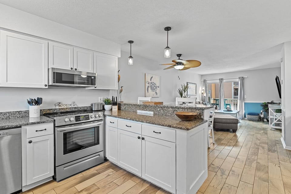 You'll love cooking in this bright, modern kitchen with granite counters, stainless appliances, and an open flow to your comfortable living area.