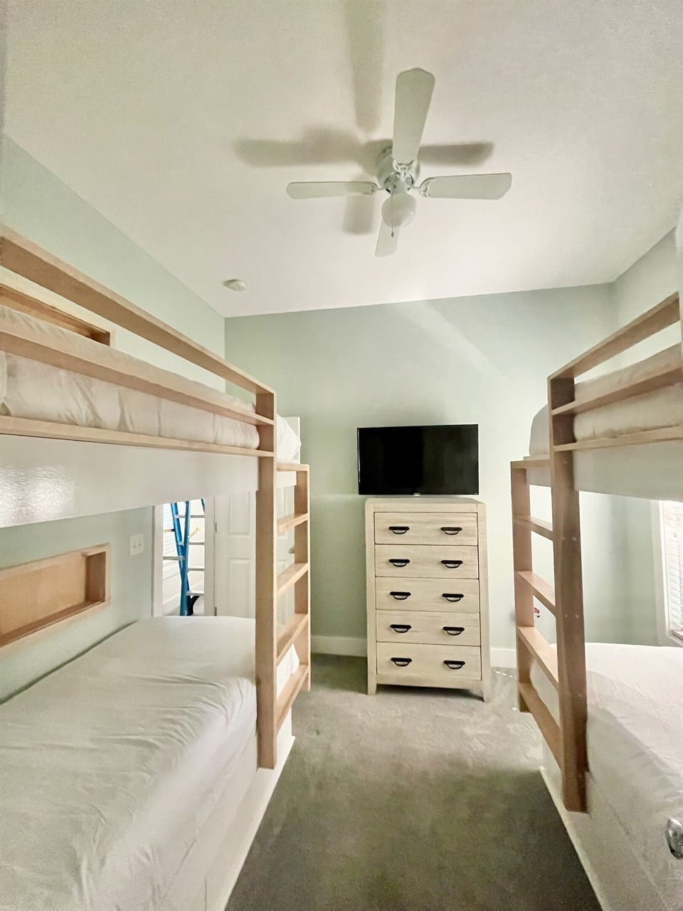 With their own Smart TV, tall dresser, closet, and ceiling fan.