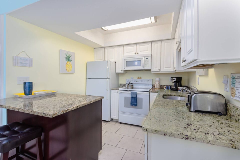 Full size kitchen with tile flooring and cooking essentials....toaster, coffeemaker and more!