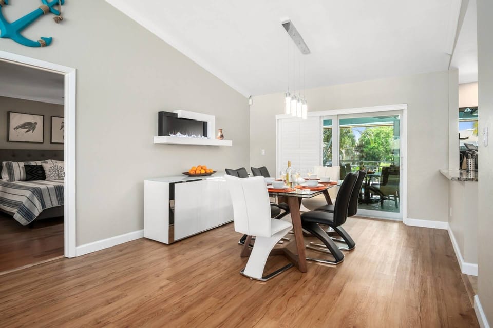 Ambiance abounds with an LED fireplace, stylish furnishings and views onto the lanai and beyond.