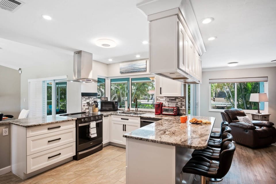 The open and airy kitchen is beautifully updated and fully equipped to meet any meal time needs.