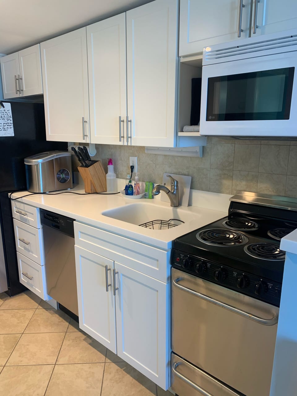 Large sink with dish washer, electric stove. Ice maker & all you need for meals.
