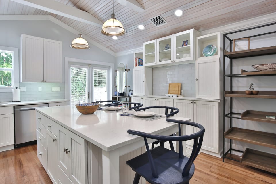 Kitchen and doors that lead to the fenced in yard.