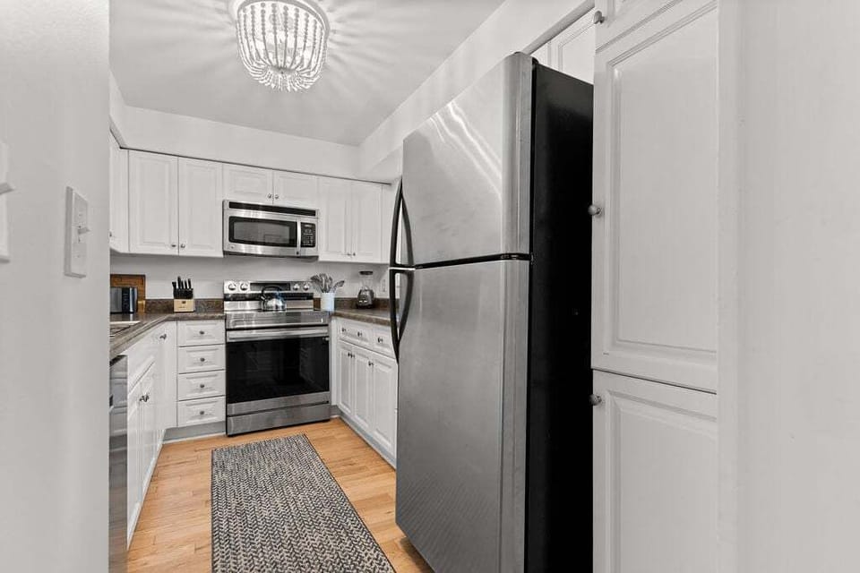 White cabinetry and stainless steel appliances in the kitchen.