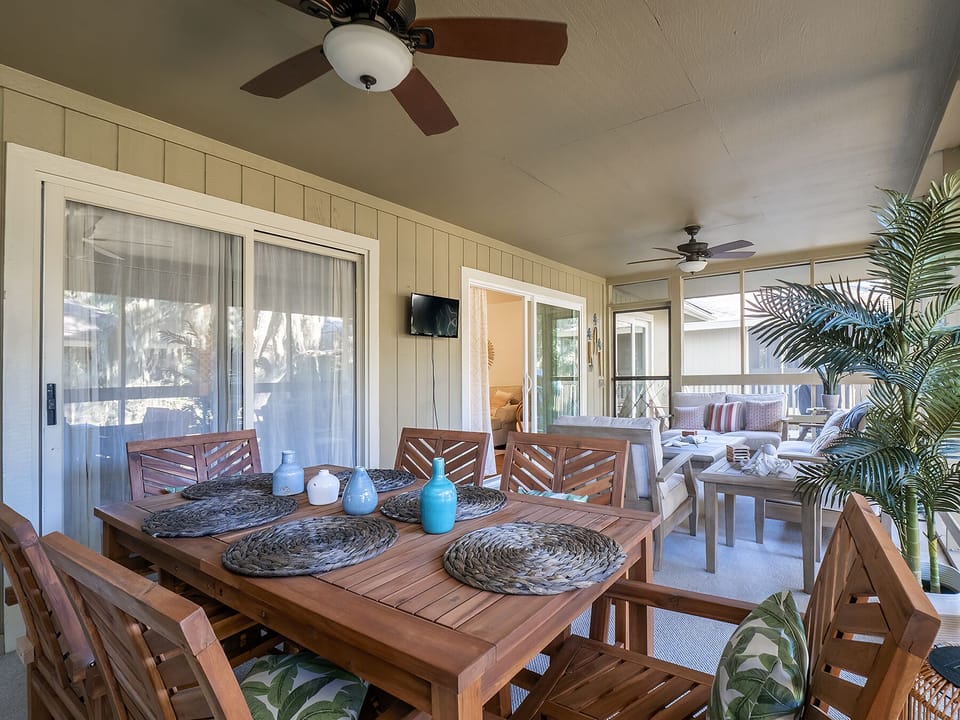 A large screen porch runs along the back of the cottage providing both a dining and seating.