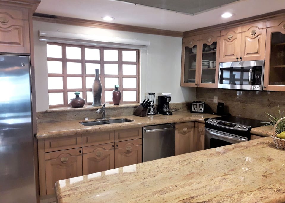 Kitchen with granite countertops, stainless steel appliances and all utensils