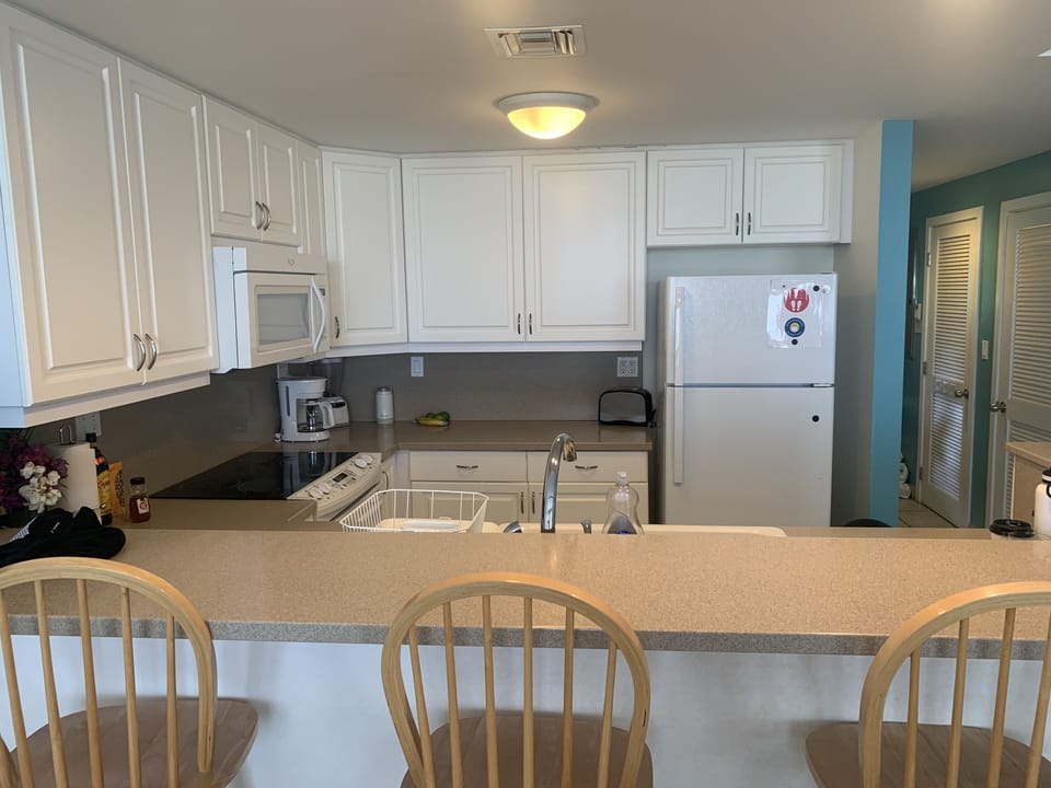 Fully stocked kitchen, pots, pans, coffee maker and blender.