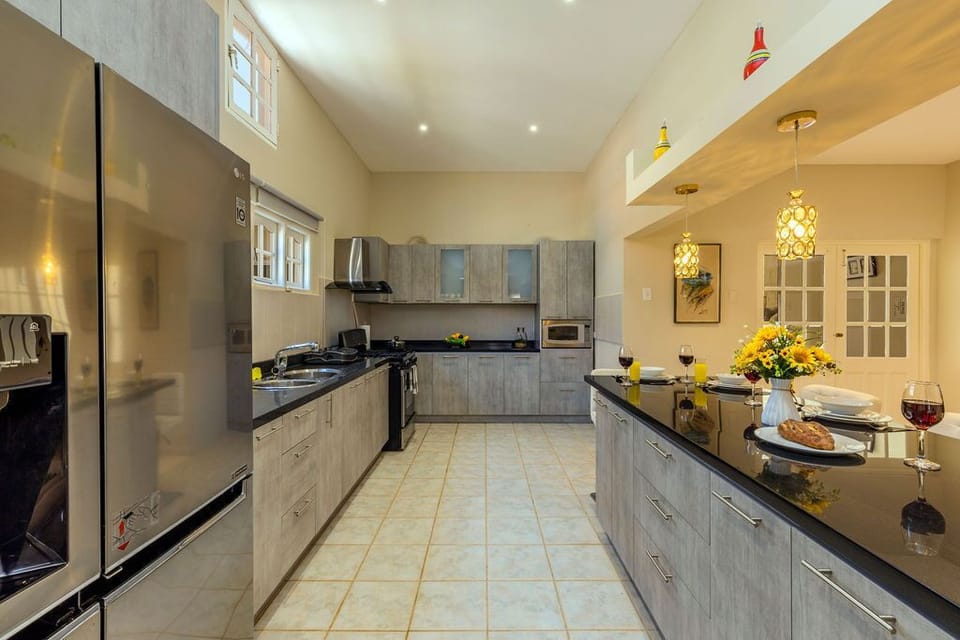 The full kitchen has a fridge, a stove, oven, vent, and microwave.