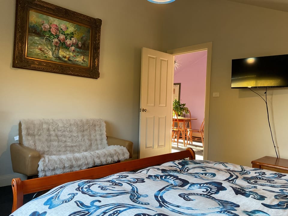 Back bedroom with TV and split system