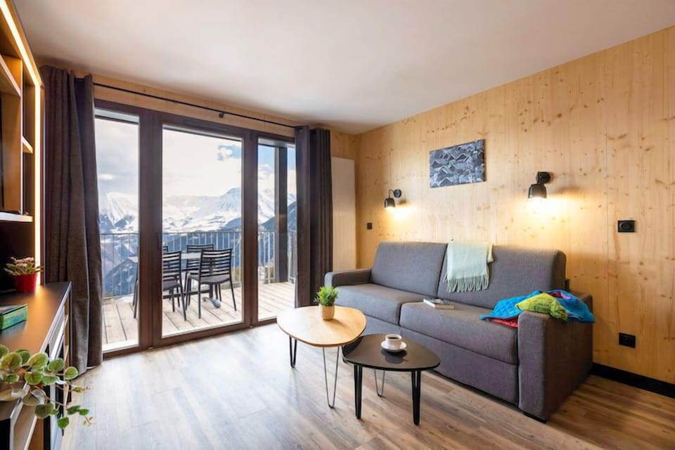 Snuggle up with a cup of coffee or tea on the comfortable sofa. Views vary.