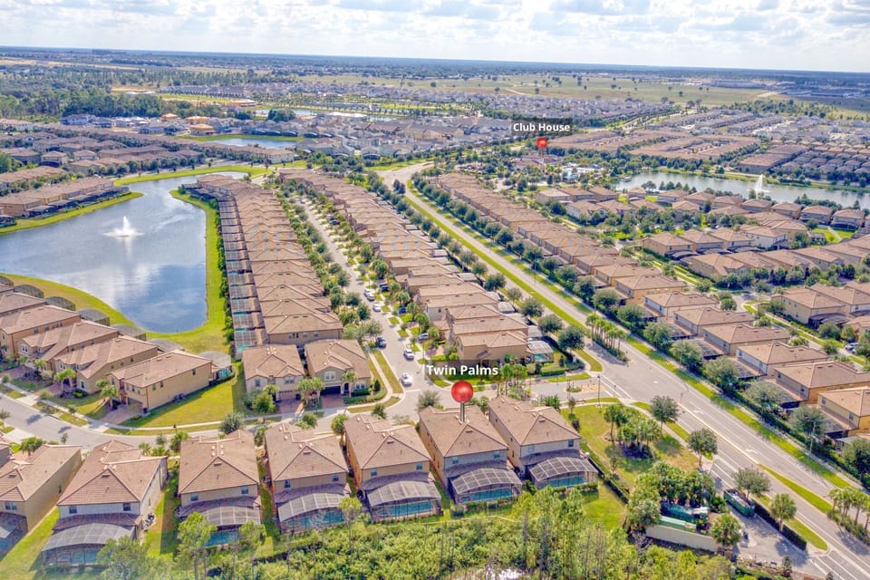 Aerial View: Embrace resort living with stunning lake views and lush landscaping at Twin Palms!