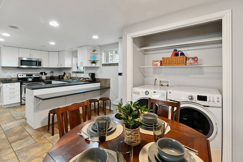 Dining Area for Four, complete with Plates, Bowls, Utensils, Glasses and Centerpiece.