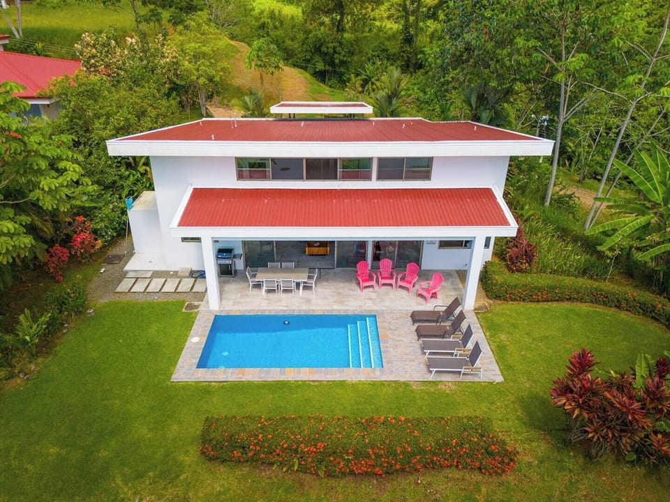 An aerial view of the house, showcasing its beautiful layout and surrounding landscape