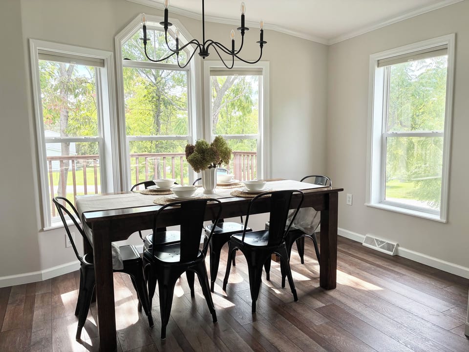 Sun drenched dining area featuring an expansive farmhouse table 